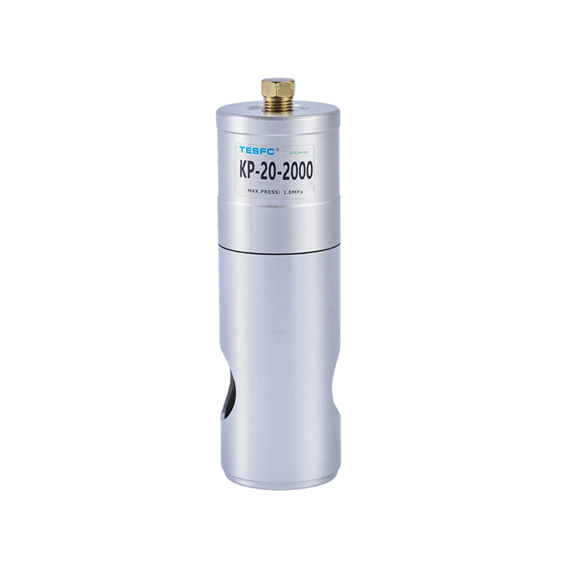 The KP device features a compact cylindrical metal body, threaded mounting section, side pneumatic port, and extended clamping rod for fixture positioning and clamping.